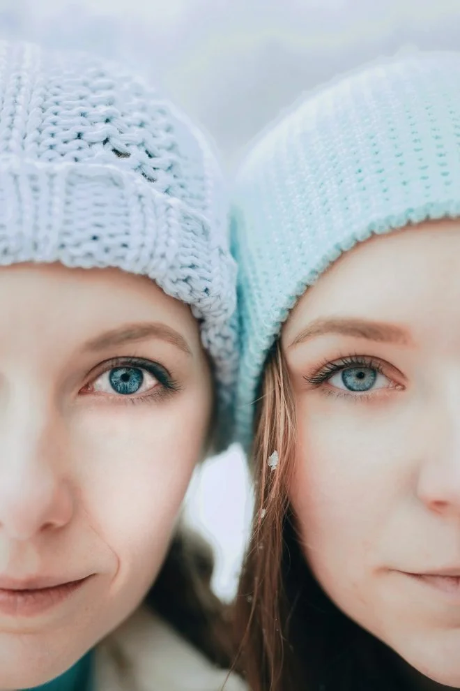 Two young girls faces close to each other